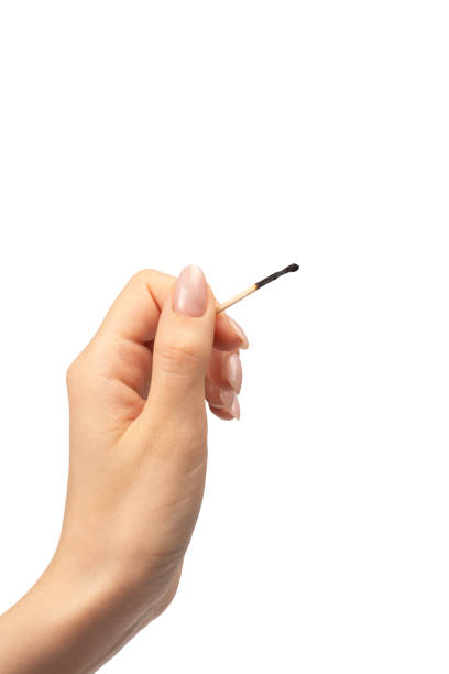 istock Lit match in a woman hand isolated on a white background. 1702612974