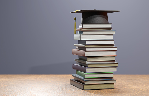 Education concept, graduation cap, books, and graduation scroll. Congratulations graduates