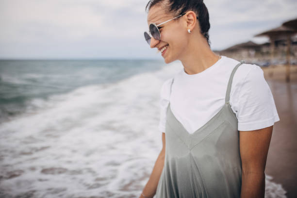 istock Woman enjoying on the beach 1702645881