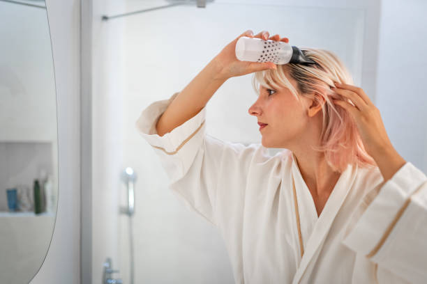 istock Young Woman doing hair care routine at home 1702661800