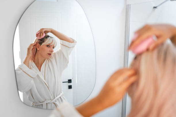 istock Young Woman doing hair care routine at home 1702662337