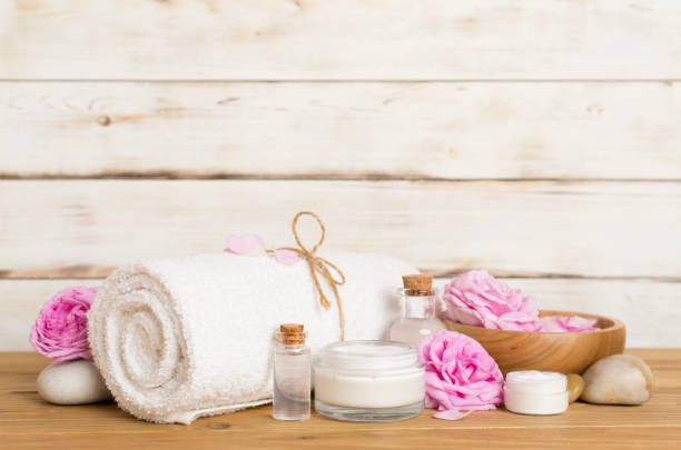 istock Spa composition with pink roses on wooden table 1702672346