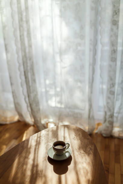 istock Morning sunshine rays and first esspresso  coffee on the table 1702690716