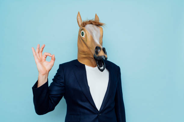 istock Businessman with horse mask 1702696226