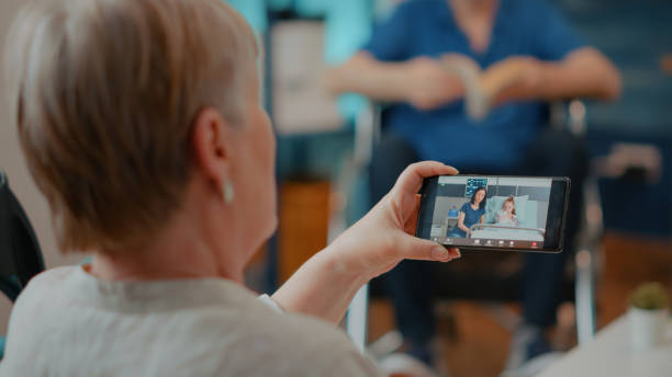 istock Grandmother using online conference call to chat with relatives 1702697843