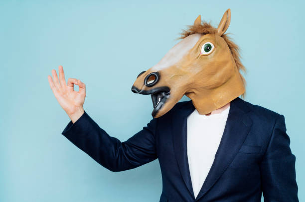 istock Businessman with horse mask 1702700544
