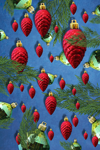 Pattern illustration of pine leaves, red and green Christmas decoration on hot blue background