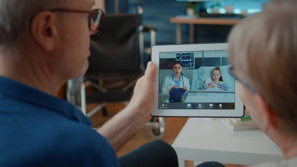 istock Retired couple holding digital tablet to talk on video call 1702713187