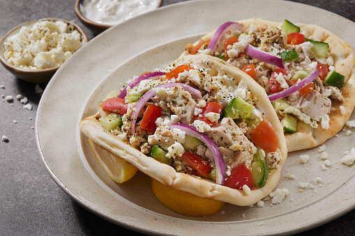 Chicken Souvlaki Gyro with Tzatziki Sauce, Feta, Cucumbers, Tomato, Spanish Onion, Lemon and Pita Bread