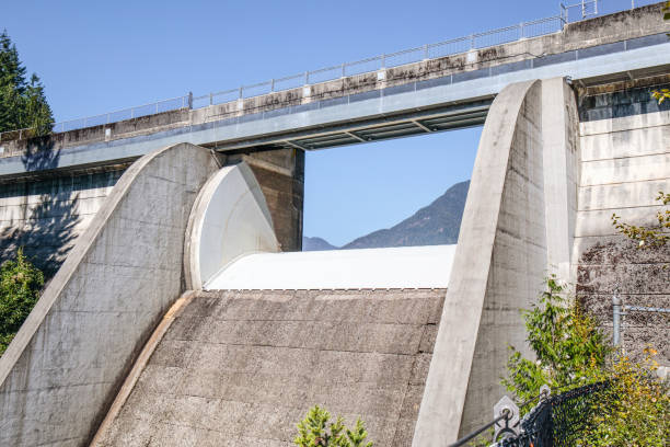 Large concrete dam with spill way and parapet wall.