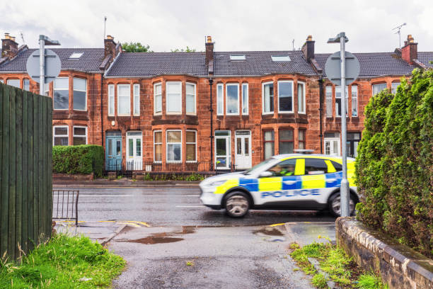 istock Police passing residential street 1702728024