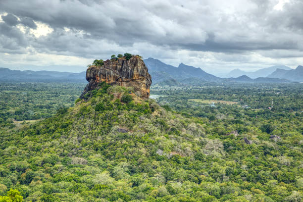 istock Ancient holy rock Sigiriya, green landscape with blue sky and clouds 1702732397