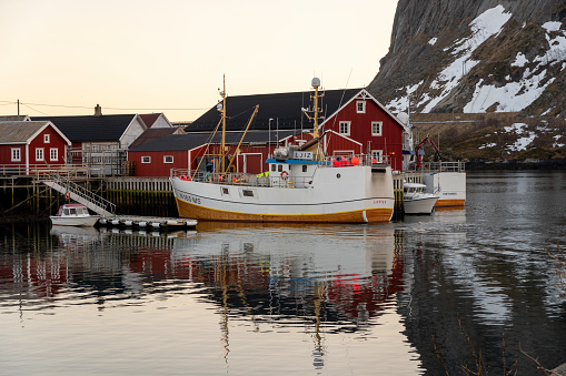 Reine at sunset in Moskenes Norland Lofoten islands in Norway on March 15, 2022. Landscape in the harbour in winter.