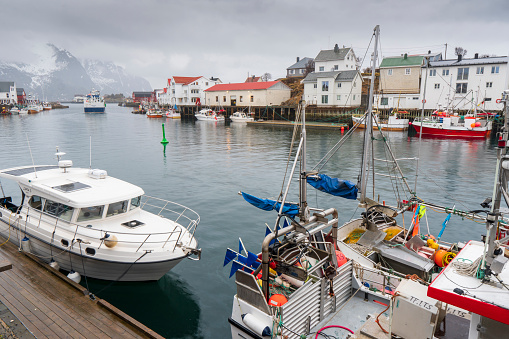 Henningsvaer  Vagan Nordland Lofoten archipelago Norway on  March 17, 2022:  Scenic view of the waterfront harbor by sunset in winter, is a fishing village and tourist town located on Austvagoya island.