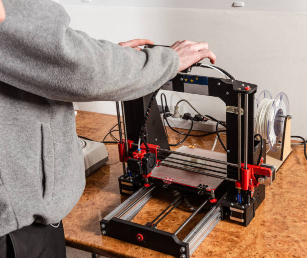 istock 3D scanning and printing training class. Teacher shows how to work on 3D scanner and printer 1702736880