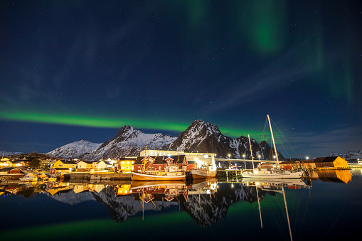 Svolvaer with the Northern lights  in Austvagoya island Vagan Nordland Lofoten archipelago  North of Norway on March 12, 2022. View from the island of Lamholmen, in the middle of Svolvær Harbour.