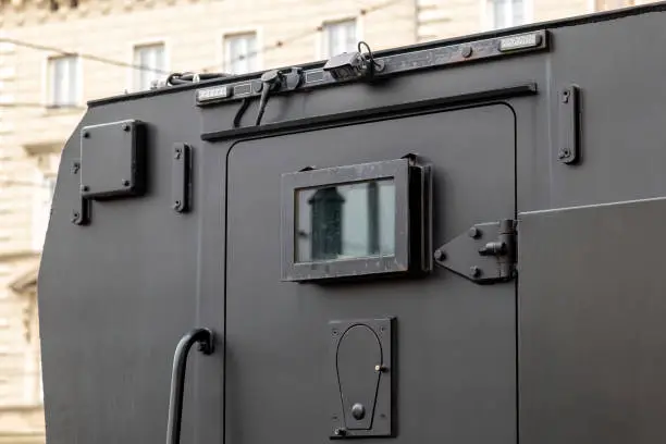Armored vehicle car truck back door detail, jail prison van, money valuables transport prisoner transportation special operations heavily armored military vehicles simple conceptual symbol closed door
