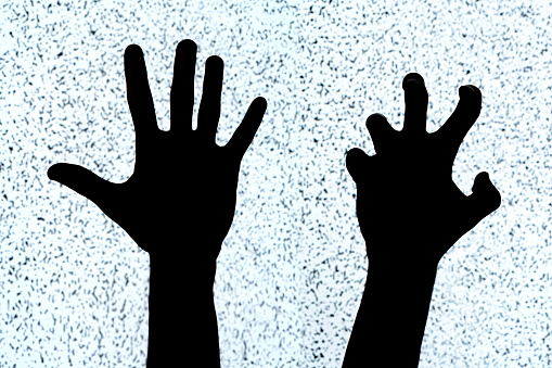 Two hands on a white noise TV screen background, black silhouettes, shapes. Scary creepy hand gestures, bent fingers, horror, simple symbol, cut out, aggression, evil, distress abstract concept