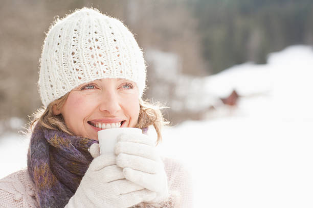 mulher bebendo café ao ar livre na neve - scarf women hat warm clothing - fotografias e filmes do acervo