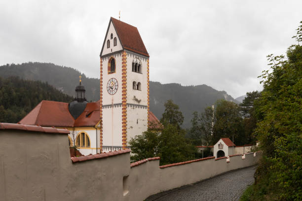 Catholic parish church St. Mang at the foot of the High Castle in Füssen. Catholic parish church St. Mang at the foot of the High Castle in Füssen in Germany. st mang stock pictures, royalty-free photos & images