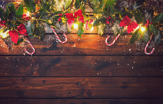 Christmas ornaments and garland on the wooden background