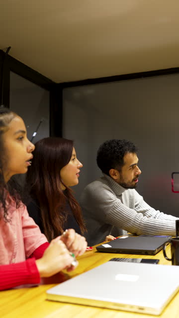 group of young Latin Americans people in a meeting room