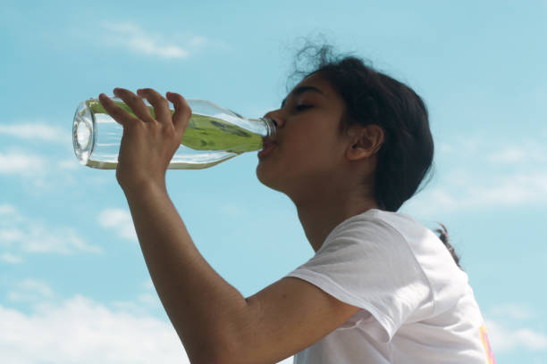 istock Young woman drinking water in nature. 1702819851