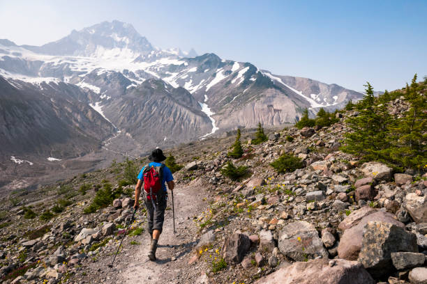 istock Solo man hiking in a vast mountain wilderness 1702826960