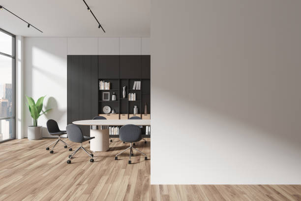 istock Stylish conference room interior with chairs and board, shelf. Mock up wall 1702829248