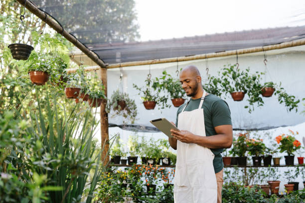 istock Plant store owner taking inventory on tablet 1702829804