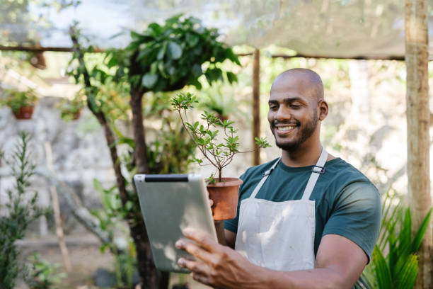 Gardening store owner showing plants on video call