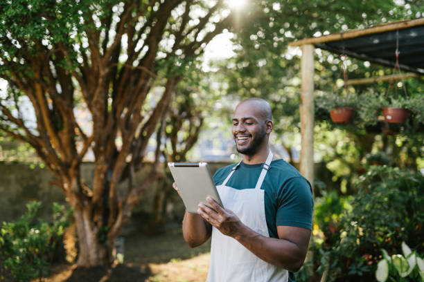 istock Garden store owner working in greenhouse 1702831965