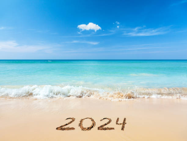 2024 written on sandy beach stock photo