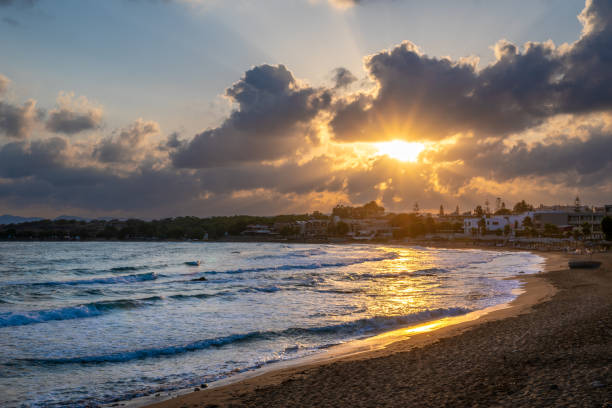 istock Fabulously shaped wave breaking on a sandy beach at sunrise in Crete 1702842564