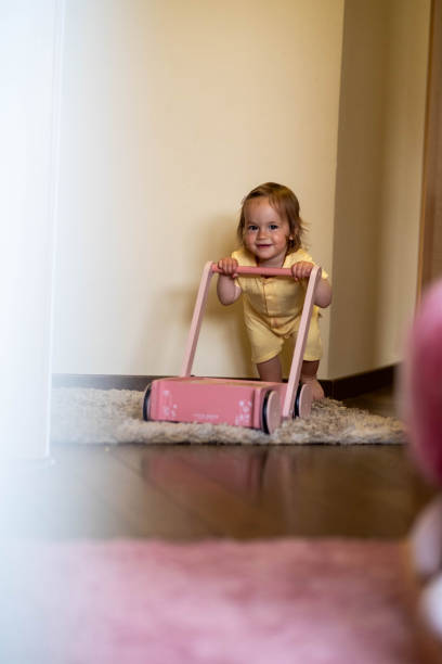 istock The baby is pushing the stroller in the room. 1702845912