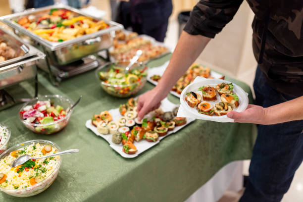 istock Self service buffet catering table with people in hotel 1702860542