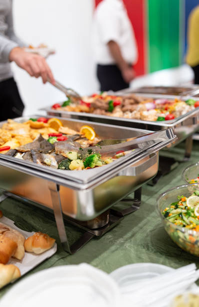 istock People scooping food. Buffet catering at restaurant or hotel concept. 1702860559