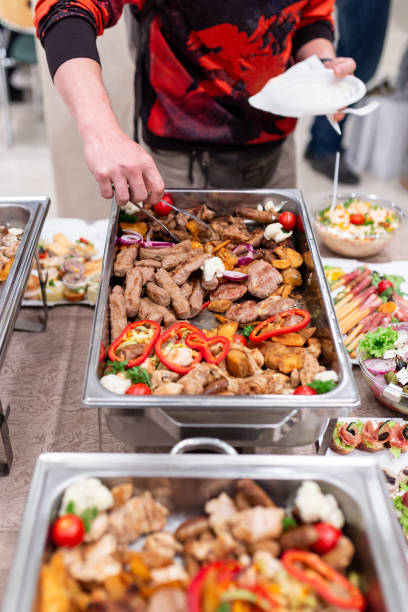 istock Fresh barbecue grill meat at buffet catering table. People serving themselves 1702861616