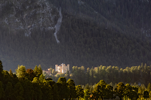 Hohenschwangau Castle on mountain top, Germany. Schloss Hohenschwangau is famous landmark of Bavarian Alps. Scenic view of old German castle, palace of King Ludwig II in Munich vicinity in summer.