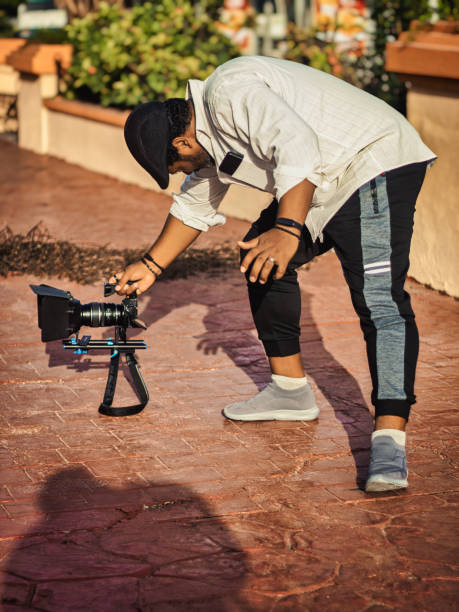 istock Filmmaker touring the city with his camera 1702896647