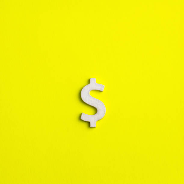 istock White dollar sign on yellow background - Business concept 1702978491