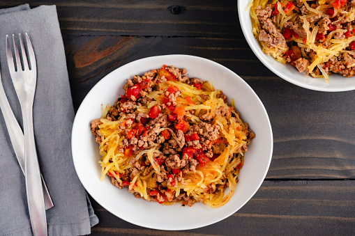 Bowls of spaghetti squash served with a ground beef and tomato sauce