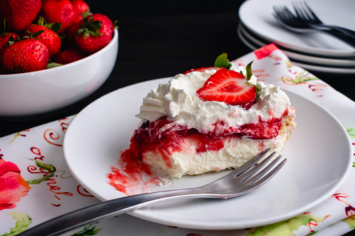 Cool summer refrigerator dessert mousse featuring angel food cake, strawberries, whipped cream/jello.