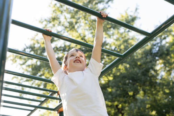 istock 6 year old boy doing sports training on the playground 1703007155