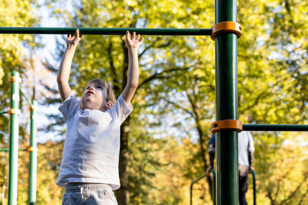 istock 6 year old boy doing sports training on the playground 1703007690