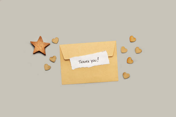 istock A brown envelope with a thank you note and a wooden star and hearts on a gray background 1703007741