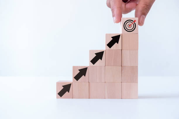 istock Business achievement goal and objective target concept. Project purpose plan and performance progress. Businessman hand putting virtual target board and arrow which print screen on wooden cube. 1703013395