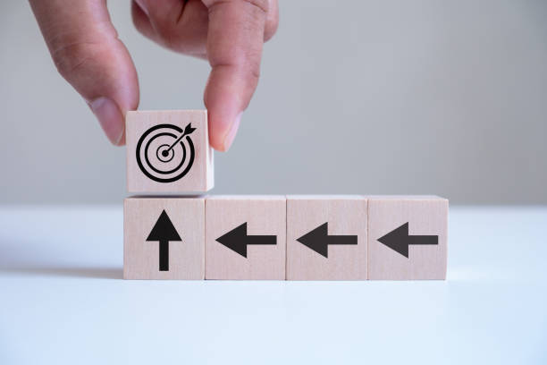 istock Businessman hand putting virtual target board and arrow which print screen on wooden cube. Business achievement goal and objective target concept. Project purpose plan and performance progress. 1703013397