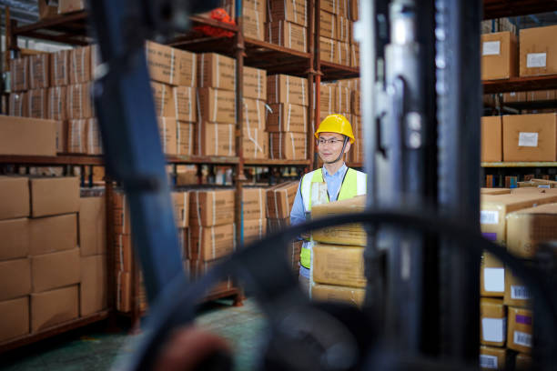 istock One Asian Warehouse Inspector Examining in Distribution Warehouse 1703085675