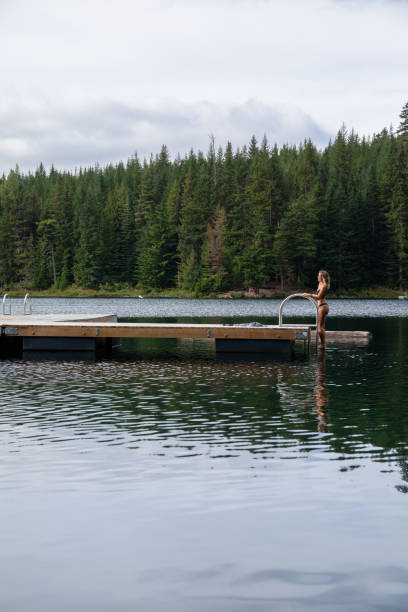 istock Young woman climbs onto pier 1703106380